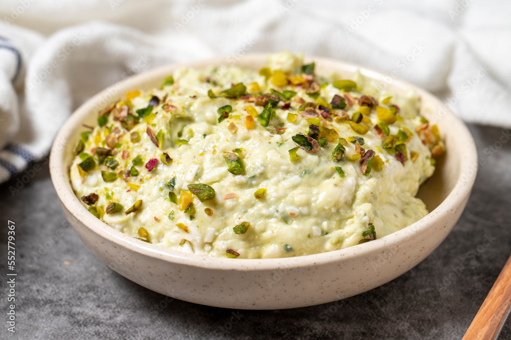 Cretan paste on dark background. Turkish cuisine appetizer flavors. An appetizer made with parsley, grated garlic, pistachios, breadcrumbs, walnuts, spices and olive oil. close up Cretan paste on dark background. Turkish cuisine appetizer flavors. An appetizer made with parsley, grated garlic, pistachios, breadcrumbs, walnuts, spices and olive oil. close up