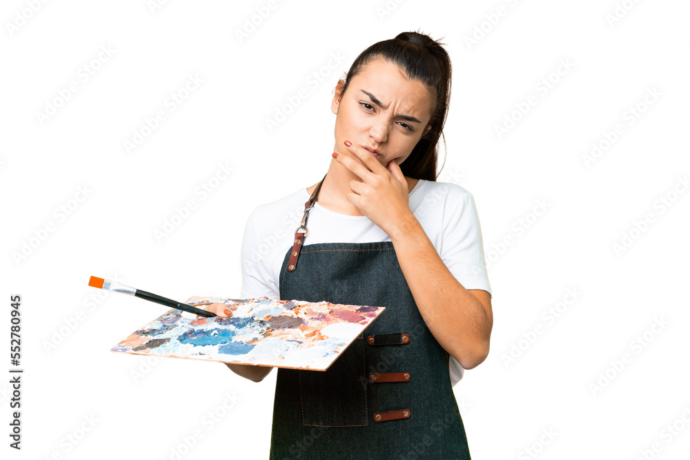 Young artist woman holding a palette over isolated chroma key background having doubts Young artist woman holding a palette over isolated chroma key background having doubts