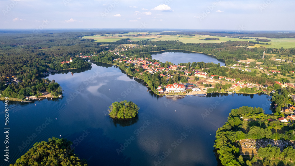 Aerial view of the old town aerial view over green forest with river in the morning. summer background of Lubniewice, poland.