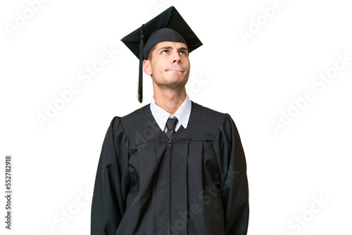 Young university graduate caucasian man over isolated background and looking up