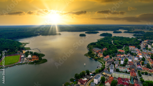 Aerial view of the old town aerial view over green forest with river in the morning. summer background of Lubniewice, poland.