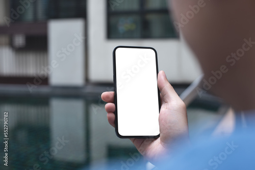 Mockup image of mobile phone for advertising. Mock up image of man hand holding and using smartphone with blank screen for mobile app design or text advertisement