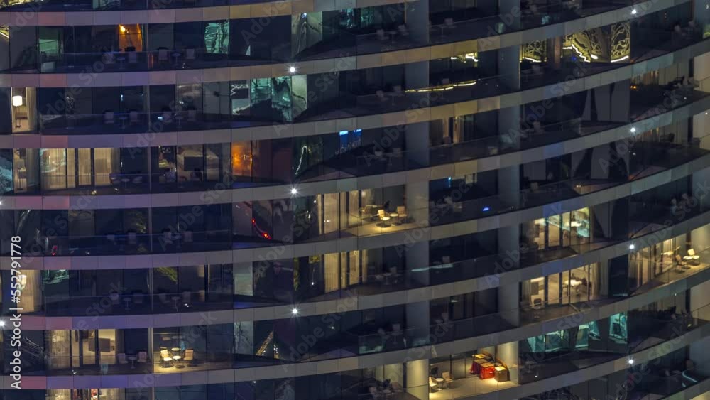 Outside view of windows in apartments of a high class building at night timelapse. Glowing lights in skyscraper with balconies Outside view of windows in apartments of a high class building at night timelapse. Glowing lights in skyscraper with balconies