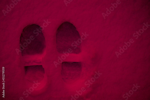 footprints from shoes in the color of the year viva magenta. High quality photo. Toned image
