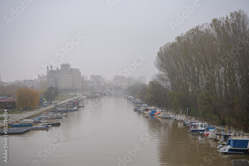 Beautiful photo of the Tamis river, on Pancevo Waterfront in the center of the city, during a foggy afternoon. Iconic silos are visible in background. One of the biggest cities of banat Pancevo, Serbi photo