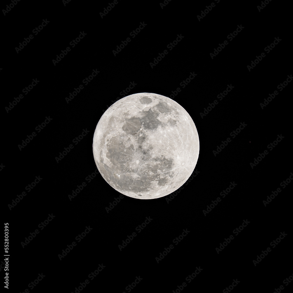 Obraz premium Beautiful soft white super full moon with details on the lunar surface in the dark night isolated on black sky background