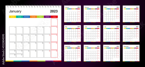Colorful wall calendar for 2023 on dark background, week starts on Monday.