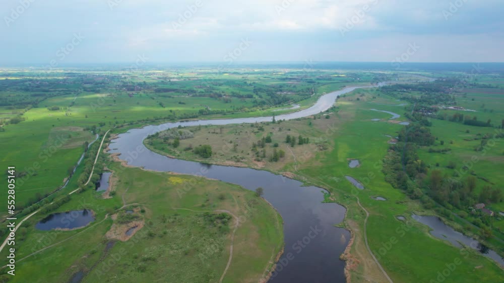 River water stream on summer greenery landscape Warta river in Poland River water stream on summer greenery landscape Warta river in Poland