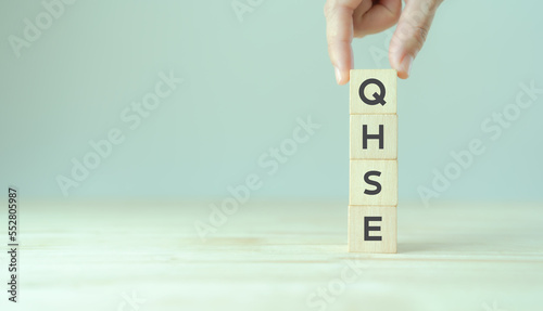 QHSE-Quality Health Safety Environment. Safety and health at workplace concept. Maximize value by successfully implementing QHSE management system. QHSE text on wooden cube blocks and copy space.