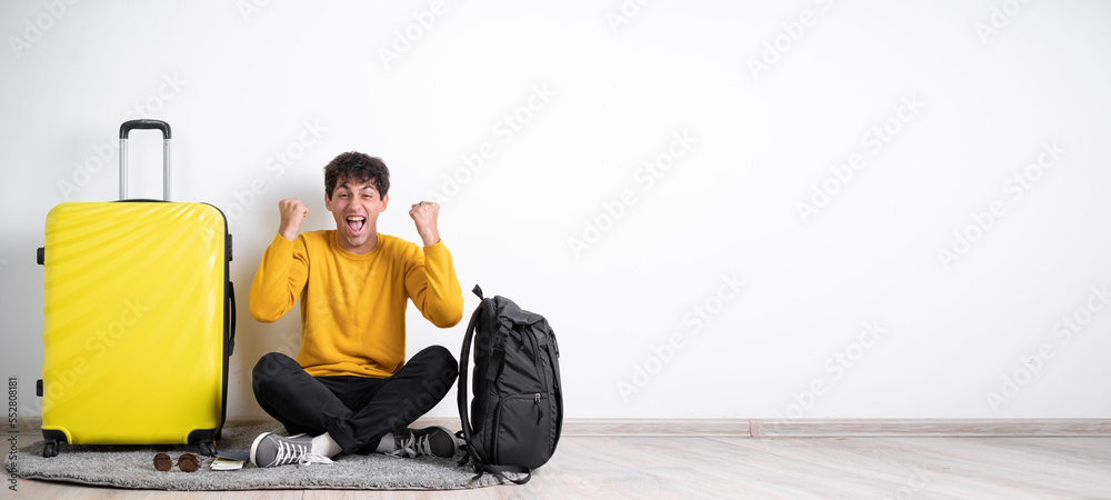 Young traveler guy with suitcase rejoice success fist hands awesome isolated over white color background Young traveler guy with suitcase rejoice success fist hands awesome isolated over white color background