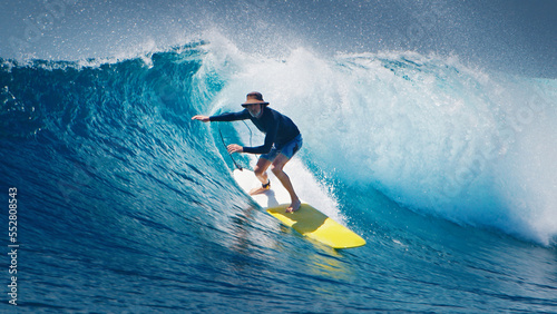 Bilde på lerret Senior surfer rides the ocean wave