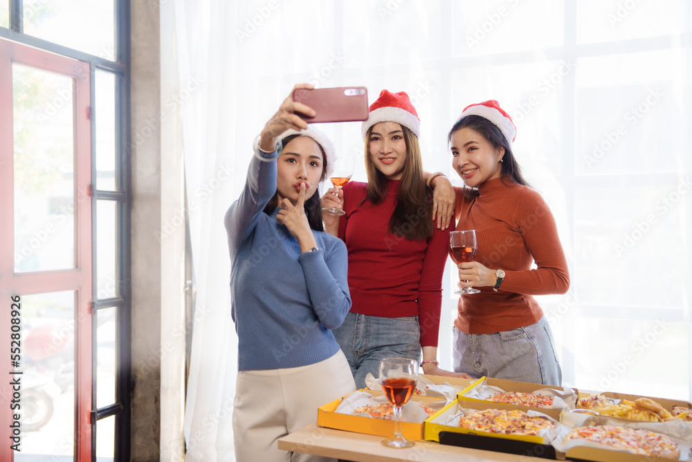 Happy young asian people friends group meeting office pizza party, laughing enjoying meal together celebration holiday and togetherness after working on christmas.