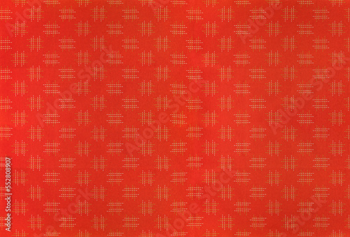 Large orange background depicting the fabric of a traditional japanese furoshiki printed with a minimalist seamless design of sharps or hashtags called igeta.