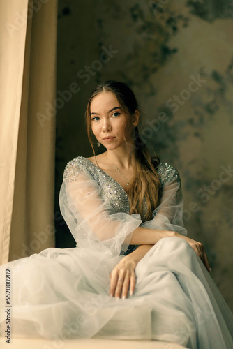 a girl in a dress against a shabby wall © artem