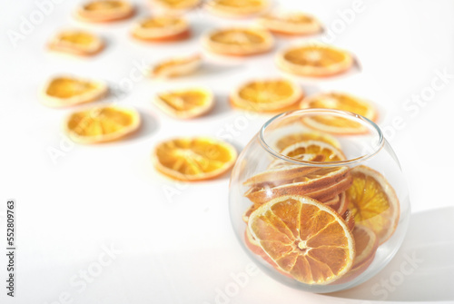  dry oranges in a vase and on a table for holiday decor. dried fruits as natural house decoration.