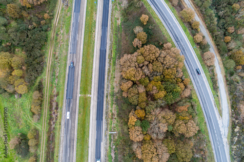Blurred defocus cars driving on a roadway, aerial view