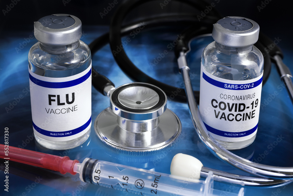 Bottles of vaccines for Influenza and Covid-19 Virus for vaccination. Flu and Sars-cov-2 Coronavirus vaccine vials in the medical clinic over Radiography pulmonar - obrazy, fototapety, plakaty 