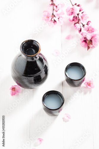 Traditional Japanese sake with blooming pink flowers.