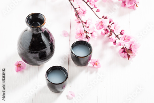 Traditional Japanese sake in small black ceramics.