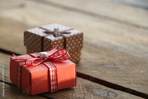 Gifts with a ribbon on a beautiful wooden background.