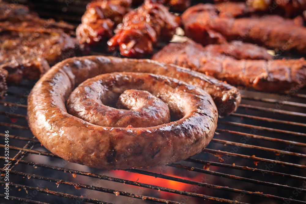 grilled sausages on the grill. South African braai with boerewors sausage.  Photos | Adobe Stock