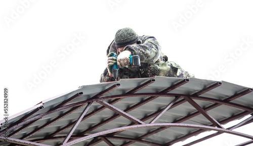 The worker sets the metal sheets on the weight.