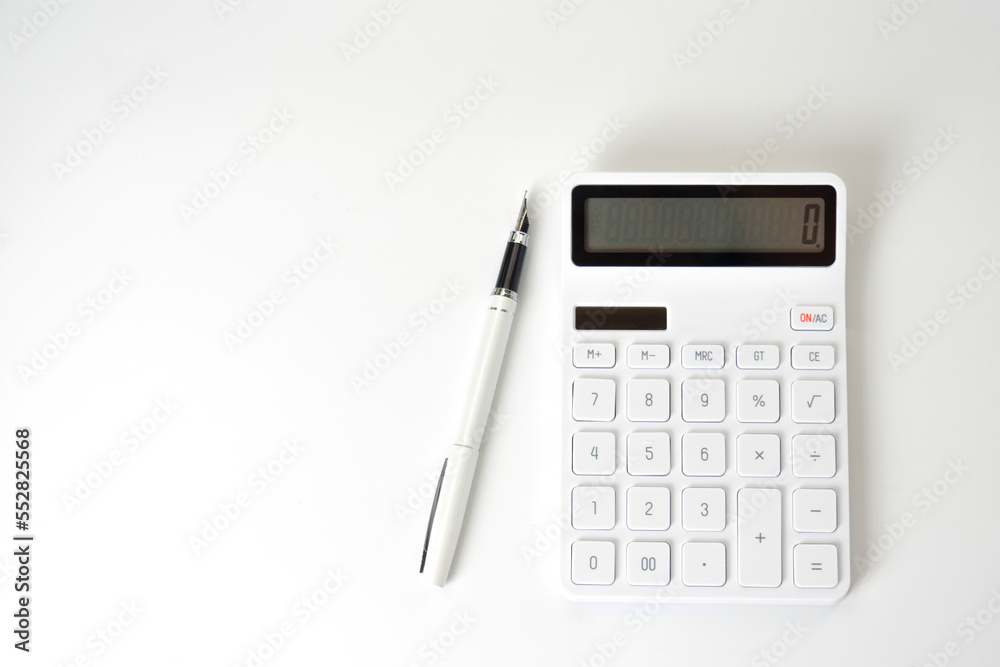 Calculator and Pen on Isolated White Background Calculator and Pen on Isolated White Background