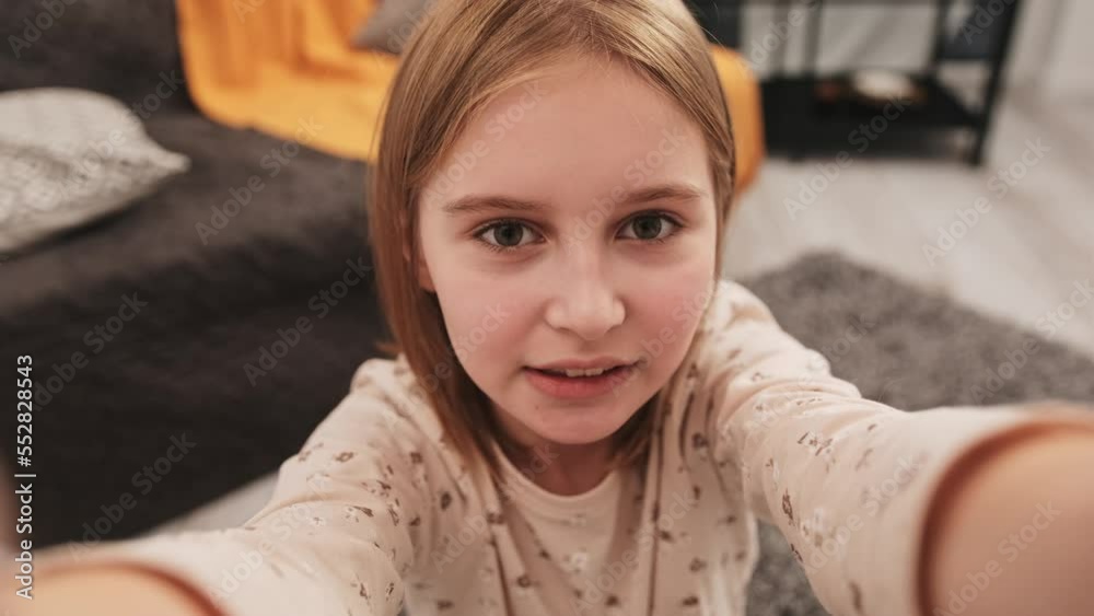 Preteen girl influencer making live stream with camera smartphone from home. Pretty kid child recording video content for social media blog Preteen girl influencer making live stream with camera smartphone from home. Pretty kid child recording video content for social media blog