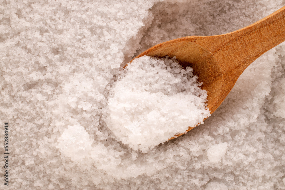 Rock salt with wooden spoon, macro, top view. Rock salt with wooden spoon, macro, top view.