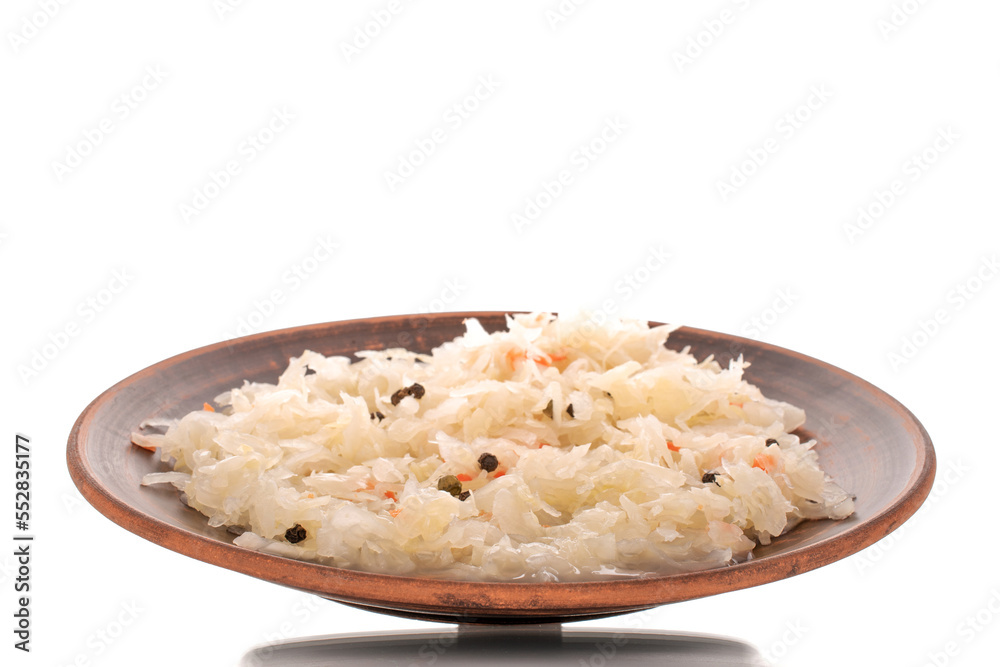 Sauerkraut in a clay plate, macro, isolated on white background. Sauerkraut in a clay plate, macro, isolated on white background.