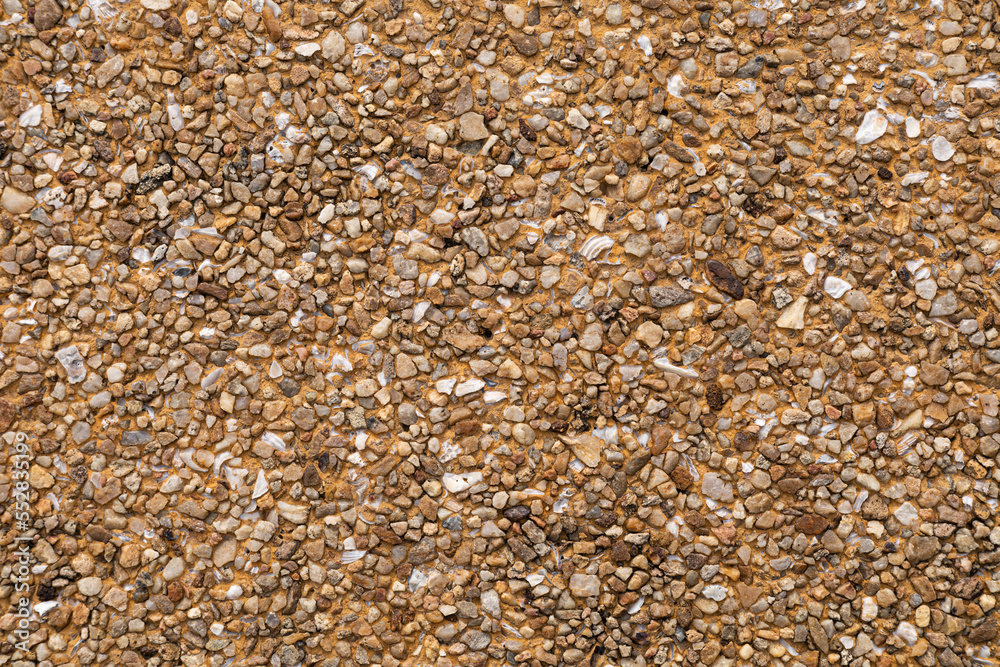 The pattern small brown pebbles stone as background. pebbles texture wall and floor. The pattern small brown pebbles stone as background. pebbles texture wall and floor.