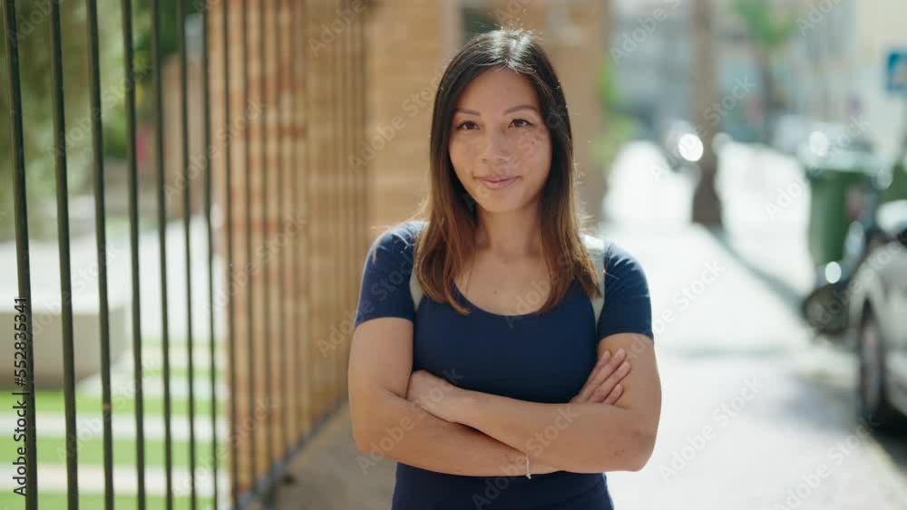 Young asian woman standing with arms crossed gesture at street Young asian woman standing with arms crossed gesture at street
