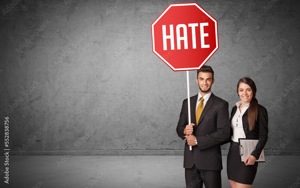 Young business person holding road sign Young business person holding road sign
