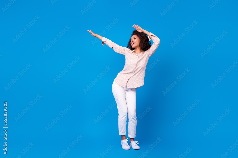 Fototapeta premium Full length photo of shiny positive lady wear pink shirt smiling dancing isolated blue color background