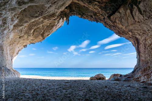 view out of one of the many seaside caves at the beach of Cala Luna in Sardinia