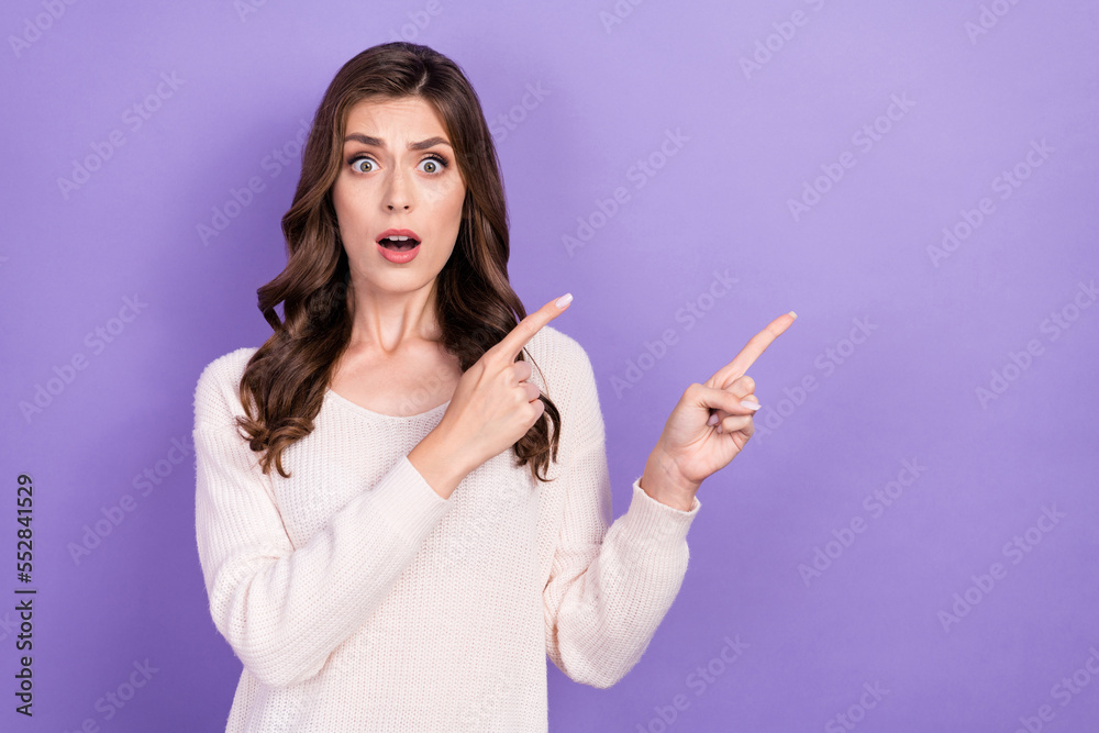 Photo of funny unhappy dissatisfied grimace lady curly brunette hairstyle fingers point empty space expensive price isolated on purple color background Photo of funny unhappy dissatisfied grimace lady curly brunette hairstyle fingers point empty space expensive price isolated on purple color background
