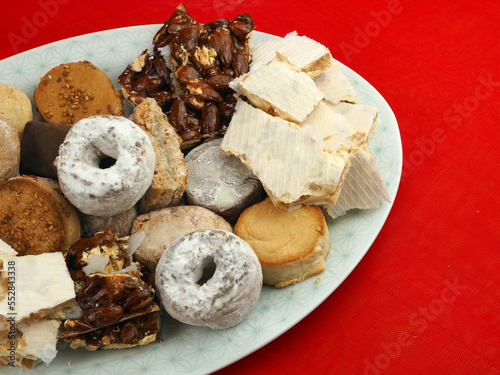 Plate of different typical sweets of Spain: turron of different kinds, mantecados and polvorones photo