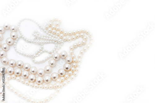 Pearl beads with beads of different sizes. Top view. Isolated