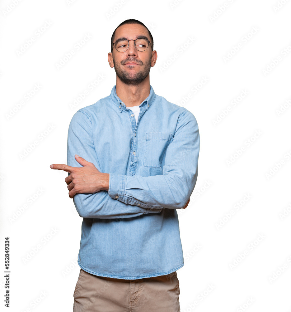 Serious young man with a gesture of disappointment Serious young man with a gesture of disappointment