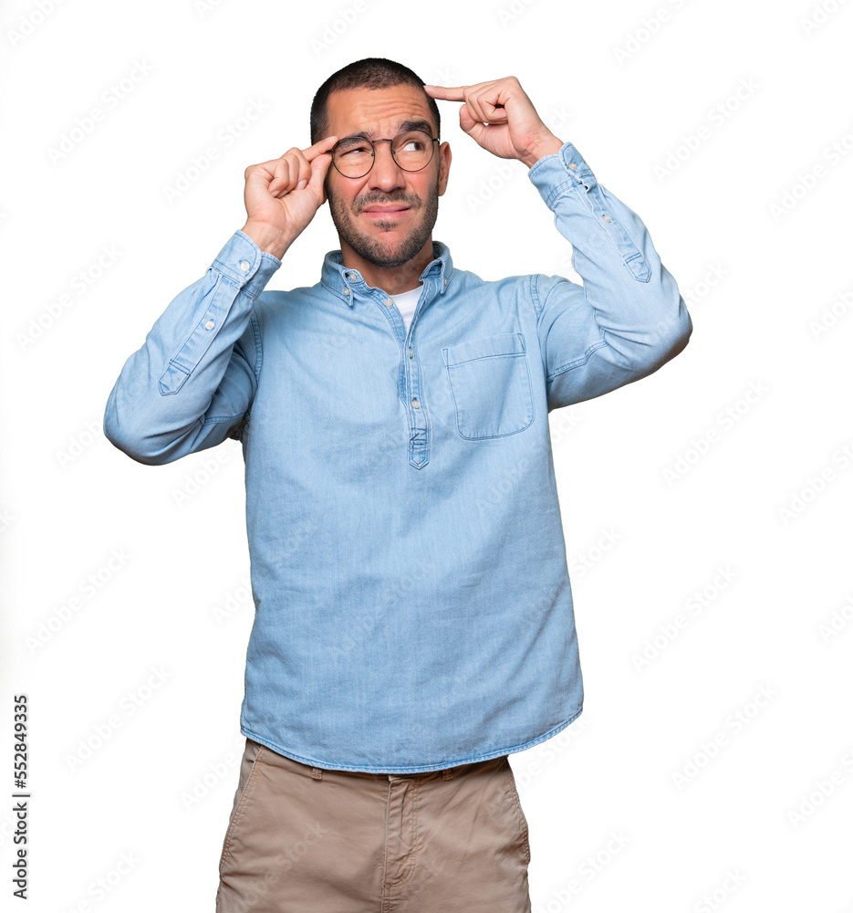 Concerned young man doing a gesture of confusion Concerned young man doing a gesture of confusion