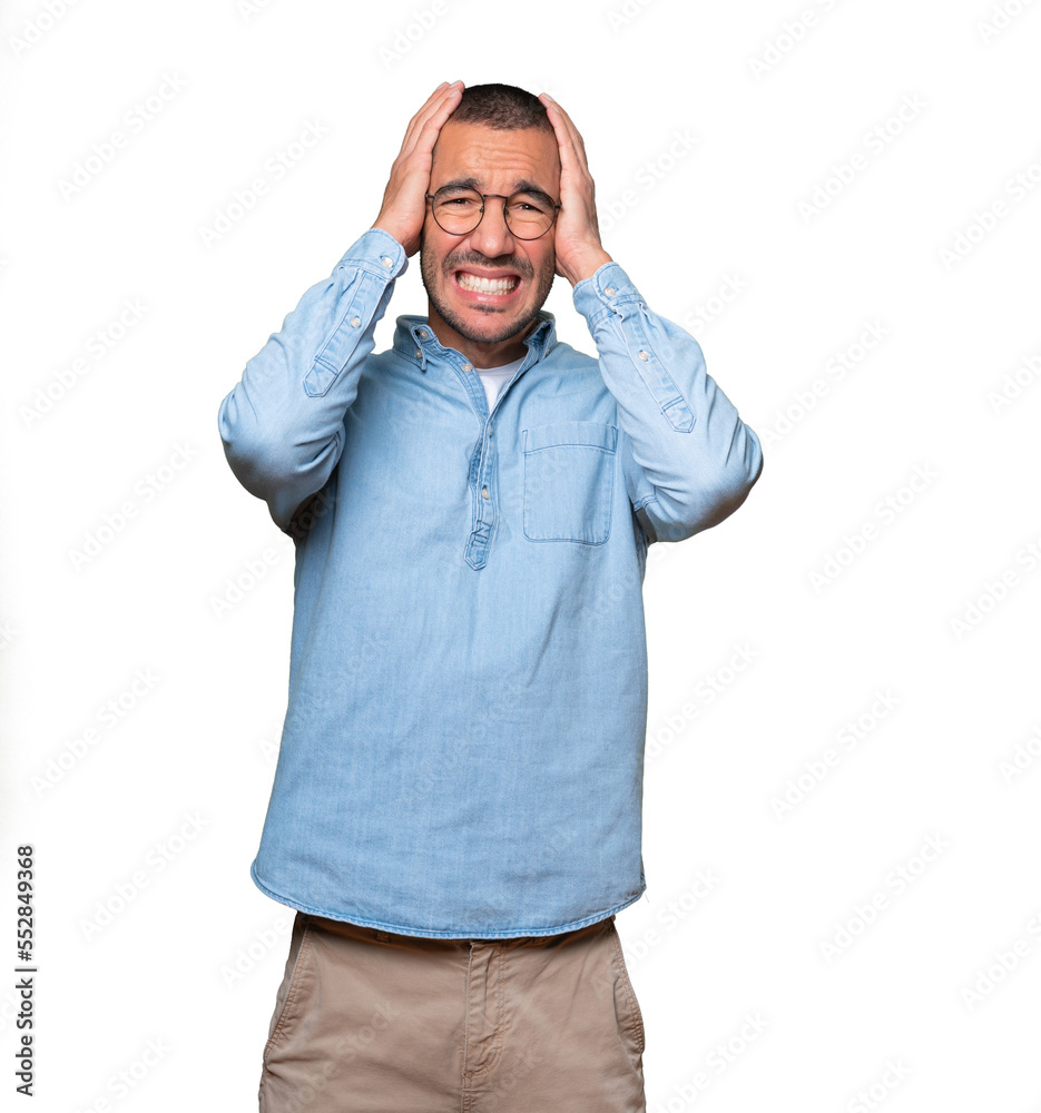 Crazy young man making a gesture of despair Crazy young man making a gesture of despair
