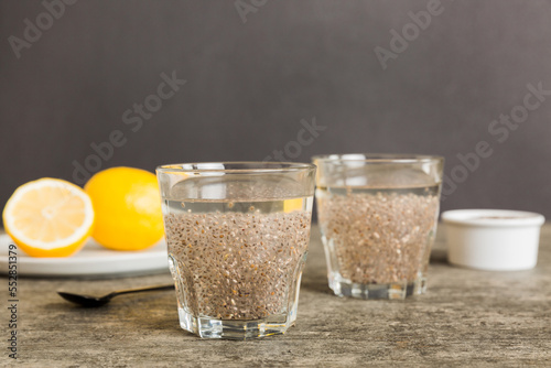 Healthy breakfast or morning with chia seeds and lemon on table background, vegetarian food, diet and health concept. Chia pudding with lemon