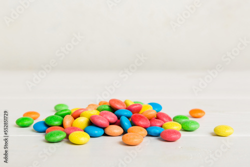 Pile of delicious colorful sweet candies on colored background top view. Confectionery decor