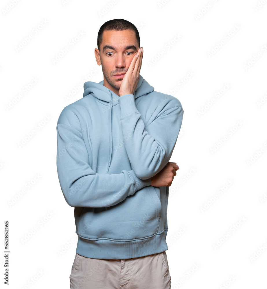 Fototapeta premium Concerned young man posing against background