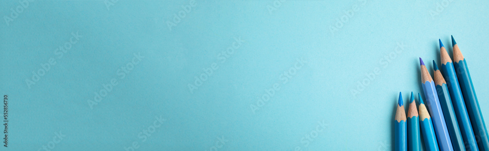 Many color pencils on light blue background, flat lay with space for text. Banner design Many color pencils on light blue background, flat lay with space for text. Banner design