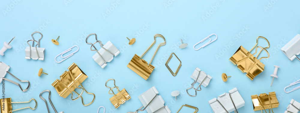 Obraz premium Binder clips on light blue background, flat lay. Banner design
