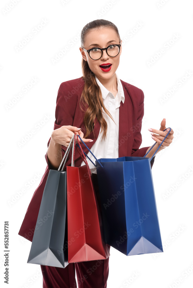 Excited young businesswoman with shopping bags on white background Excited young businesswoman with shopping bags on white background