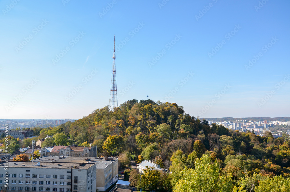 Autumn scenery view of observation deck, on the High Castle Hill covered colorful trees in Lviv, Ukraine