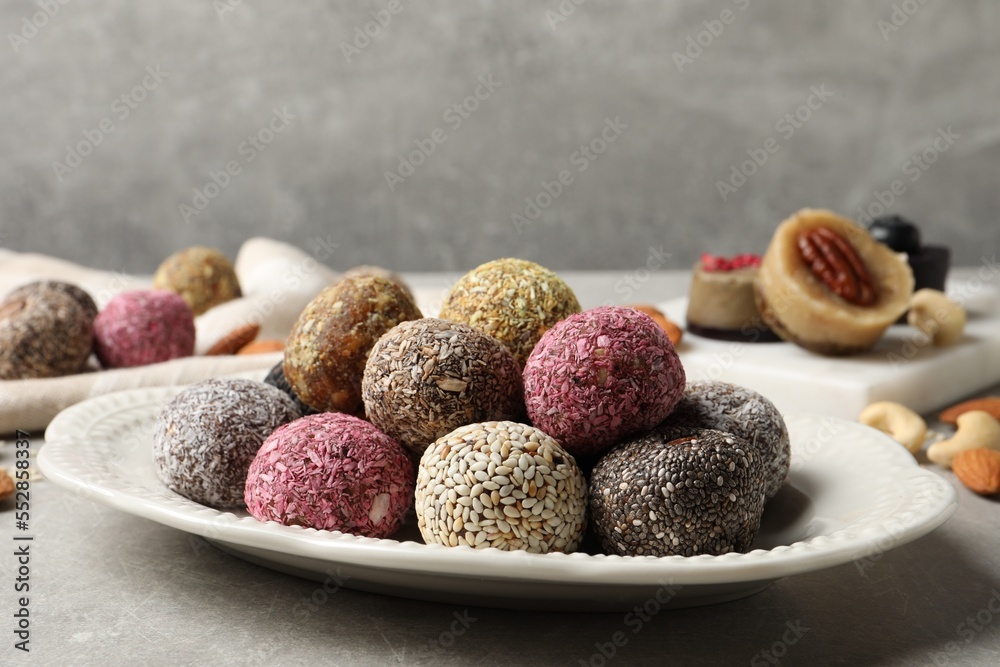 Different delicious vegan candy balls on grey table Different delicious vegan candy balls on grey table
