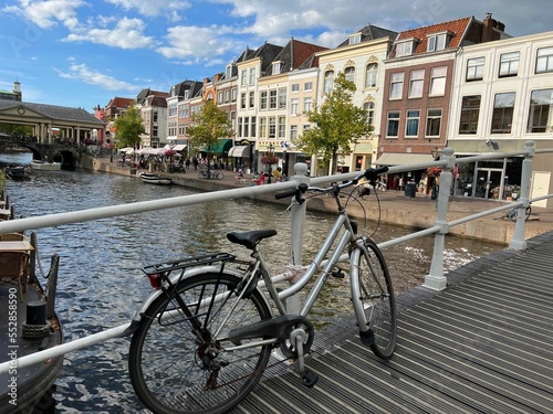 Beautiful view of bicycle on pedestrian bridge near canal in city